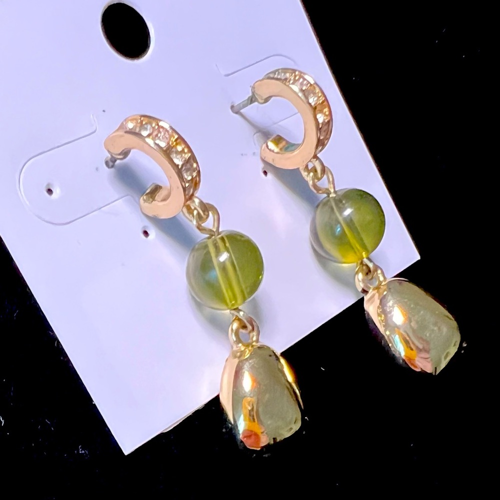 earrings made of yellow metal with a green stone and white cubic zirconia.